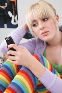 a sad woman staring at her phone